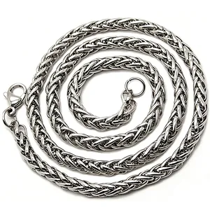 Detailed macro view of heavy stainless steel wheat chain necklace in silver finish