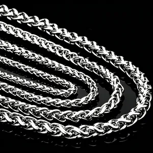 Close-up detail of silver stainless steel dragon bone wheat chain necklace for men