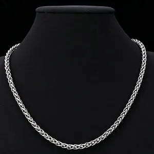 Detailed close-up of a masculine silver stainless steel wheat chain necklace.