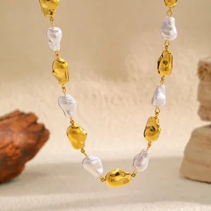 Close-up detail of irregular baroque pearls and polished gold beads on luxury necklace