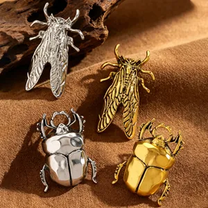 Detailed view of creative metal beetle and insect rings in gold and silver finishes.