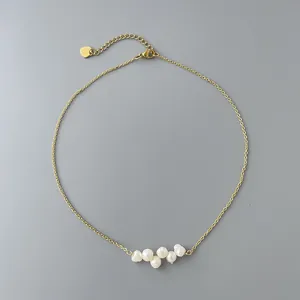 Close-up of elegant 18k gold plated necklace featuring natural freshwater pearls.
