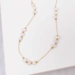 Close-up of elegant freshwater pearls on a delicate 18k gold plated chain.