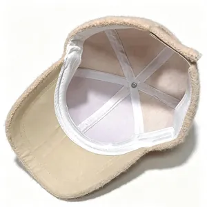 Detailed interior view of a plush beige baseball cap showing white lining and seams