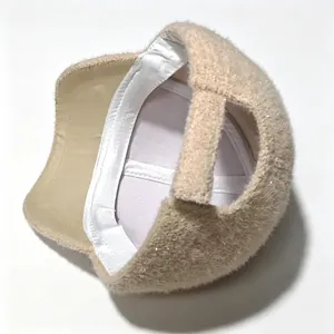 Detailed view of the interior lining and plush rhinestone texture of the beige cap