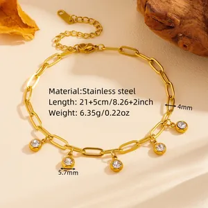 Close-up of gold stainless steel paperclip bracelet featuring five crystal charms.