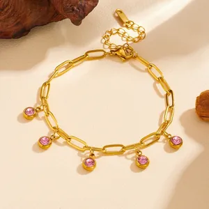 Detailed close-up view of a gold titanium steel bracelet with five pink crystal charms.