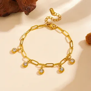 Detail shot of a gold titanium steel paperclip bracelet with five clear crystal charms