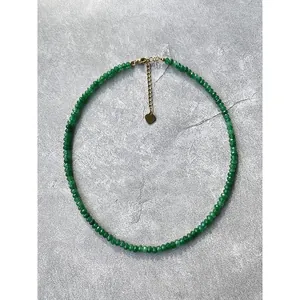 Detailed view of handmade green natural stone beaded necklace with 18k gold heart charm