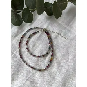 Detailed view of colorful natural stone beads on a handmade necklace with silver clasp