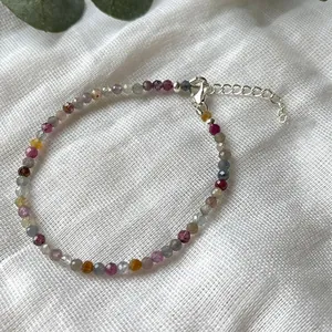 Detailed shot of multi-color faceted natural stone beaded bracelet with silver clasp.