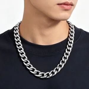 Close-up of a chunky silver titanium steel Cuban link chain necklace on model
