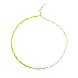 Handmade seed bead necklace with white freshwater pearls in yellow and white split design