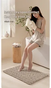 Absorbent chenille bath mat shown in a professional modern warm-toned bathroom setting