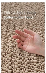 Macro detail of thick beige chenille bathroom mat with soft shaggy texture and deep pile