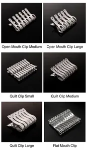 Macro view of various stainless steel windproof quilt clips in different sizes and shapes.
