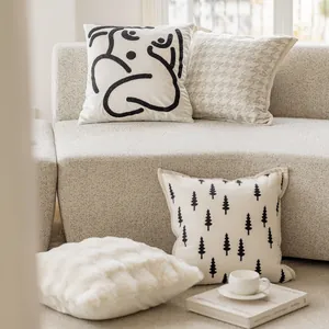 Assorted cream-style cushion covers with minimalist patterns in a cozy living room