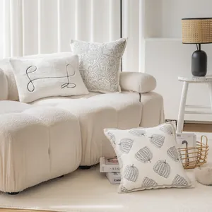 Modern cream bouclé sofa lifestyle scene with decorative patterned throw pillow covers
