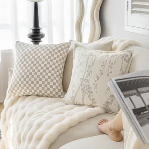 Luxury cream style decorative pillowcases displayed on a cozy sofa with faux fur blanket