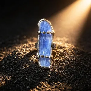 Close-up of vintage adjustable ring featuring natural blue kyanite stone and bead chain details