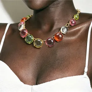 Close-up of bohemian colorful jelly stone choker necklace on a dark-skinned model