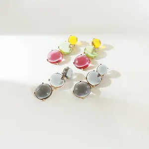 Close-up of bohemian geometric earrings with colorful translucent jelly-like resin segments