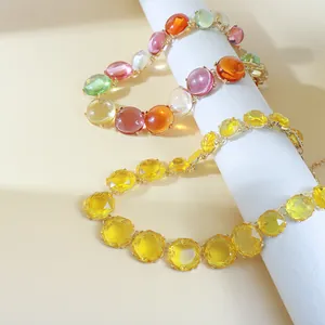 Detailed view of bohemian style jelly color-clashing choker and yellow geometric gemstone necklaces