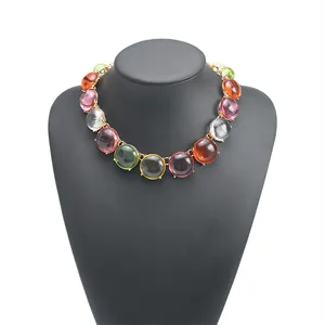 Close-up detail of bohemian colorful jelly bead necklace with gold setting