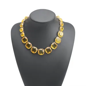 Detail view of Bohemian yellow jelly geometric necklace on black mannequin display