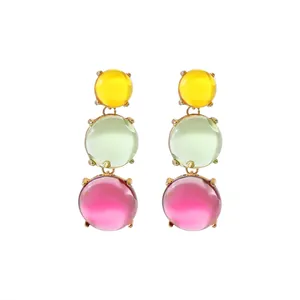 Macro view of bohemian geometric drop earrings with three-color jelly beads on white background