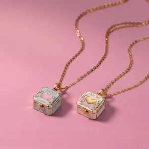 Detail of square MOM locket necklaces in blue and white with floral heart designs.