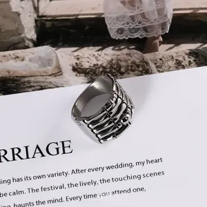 Detailed view of a trendy punk titanium steel skeleton hand ring with silver finish