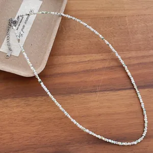 Close-up detail of 2mm natural freshwater shell bead necklace with stainless steel clasp