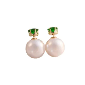 Elegant double-sided pearl earrings with green crown-set zircon on white background