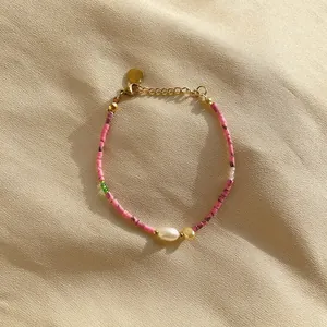 Detailed view of handmade Bohemian beaded bracelet featuring pink beads and white pearl
