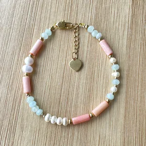 Detailed macro view of bohemian handmade beaded bracelet with pink coral beads and white pearls