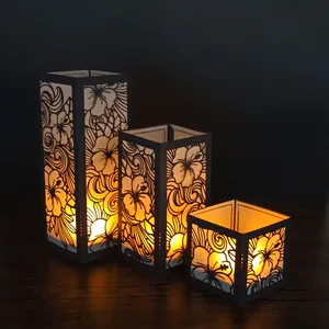 Vue détaillée de trois lanternes en papier hibiscus noir découpées au laser avec lumière
