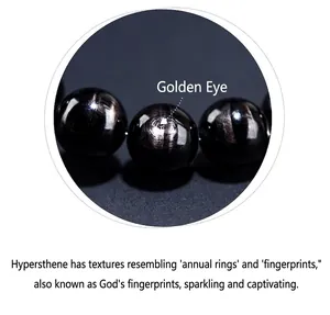 Close-up of natural Hypersthene beads showing unique golden eye and wood grain texture