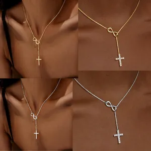 Detail view of 18K gold and silver infinity cross necklaces with CZ stones.