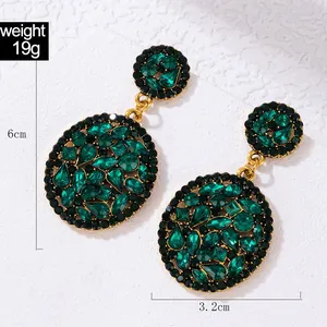 Detailed view of green crystal earrings showing 6cm length and 3.2cm width