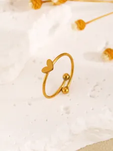 Detailed view of a dainty gold-tone heart ring featuring a smooth polished finish.