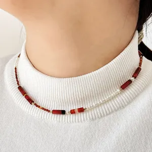 Detailed view of a retro natural stone and pearl beaded necklace worn on a model's neck