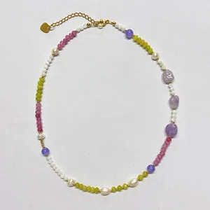 Detailed shot of mixed natural stone beaded necklace with a golden heart charm