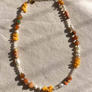 Detailed view of handmade vintage necklace with mixed natural stones and pearls