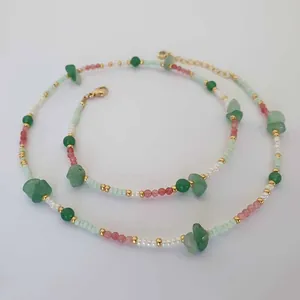 Detail of handmade vintage natural stone and mixed colorful beaded necklace and bracelet set
