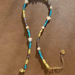 Detailed view of vintage natural stone beaded necklace with pearls and star accents