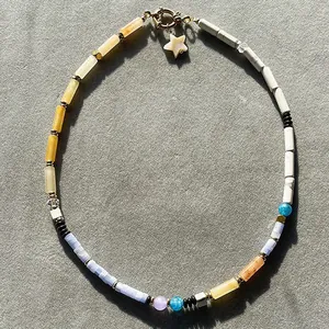 Detailed macro shot of vintage mixed natural stone beaded necklace with a shell star charm