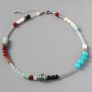 Close-up view of vintage natural stone beaded necklace with mixed pearls and gems.