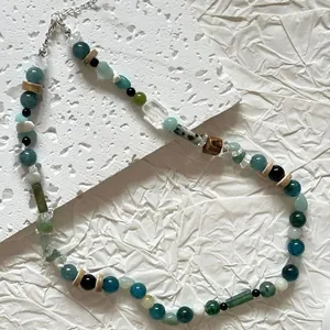 Detailed close-up of vintage mixed natural stone beads with wooden spacers and textures