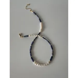 Detailed view of handmade vintage natural blue stone and pearl beaded choker necklace.